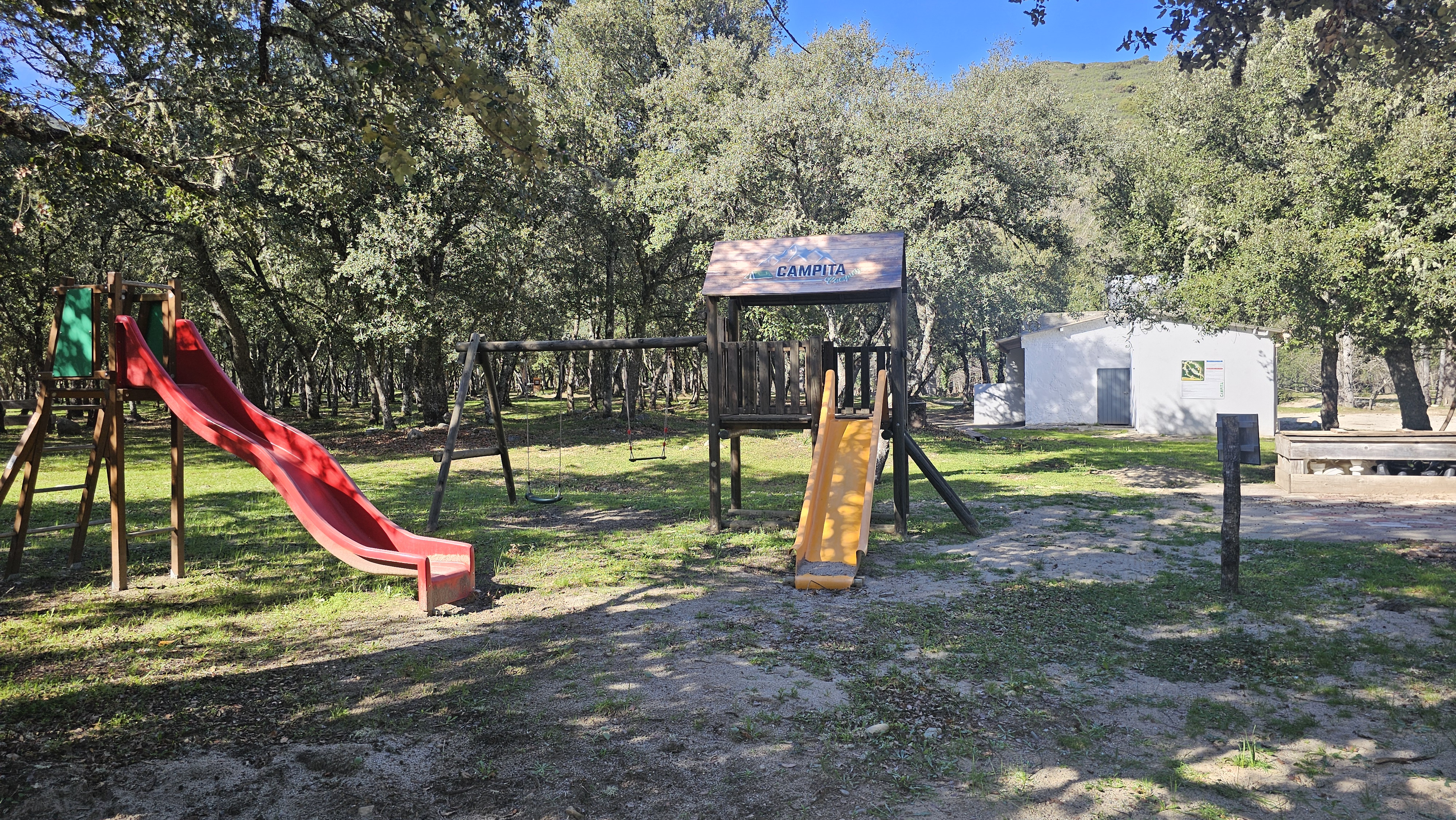 Play area at the Campita campsite, with trampolines, slides, swings